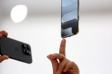 A person points to an iPhone during Apple's event at the Steve Jobs Theater on its campus in Cupertino, California, U.S. September 9, 2025. REUTERS/Manuel Orbegozo