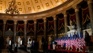 U.S. flags are illuminated on an event stage erected in Statuary Hall after U.S. President Donald Trump cancels a scheduled signing of a bipartisan legislation aimed at speeding up ​the construction and availability of more affordable housing, at the U.S. Capitol in Washington, D.C., U.S., June 24, 2026. REUTERS/Elizabeth Frantz