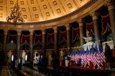 U.S. flags are illuminated on an event stage erected in Statuary Hall after U.S. President Donald Trump cancels a scheduled signing of a bipartisan legislation aimed at speeding up the construction and availability of more affordable housing, at the U.S. Capitol in Washington, D.C., U.S., June 24, 2026. REUTERS/Elizabeth Frantz