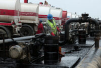 Men work during the unloading of oil from trucks arriving from Iraq at the Baniyas oil terminal, in Baniyas, Syria, May 14, 2026. REUTERS/Mahmoud Hassano/File Photo