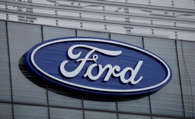 The blue Ford oval logo is displayed on the new Ford World Headquarters in Dearborn, Michigan, U.S. November 16, 2025. REUTERS/Rebecca Cook/File Photo