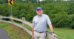 David Perry, executive director of the Blue Ridge Land Conservancy, stands in front of a section of Evans Spring. Photo by Natalee Waters