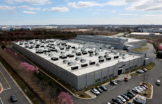 A car drives past a building of the Digital Realty Data Center in Ashburn, Virginia, U.S., March 17, 2025. REUTERS/Leah Millis/File Photo