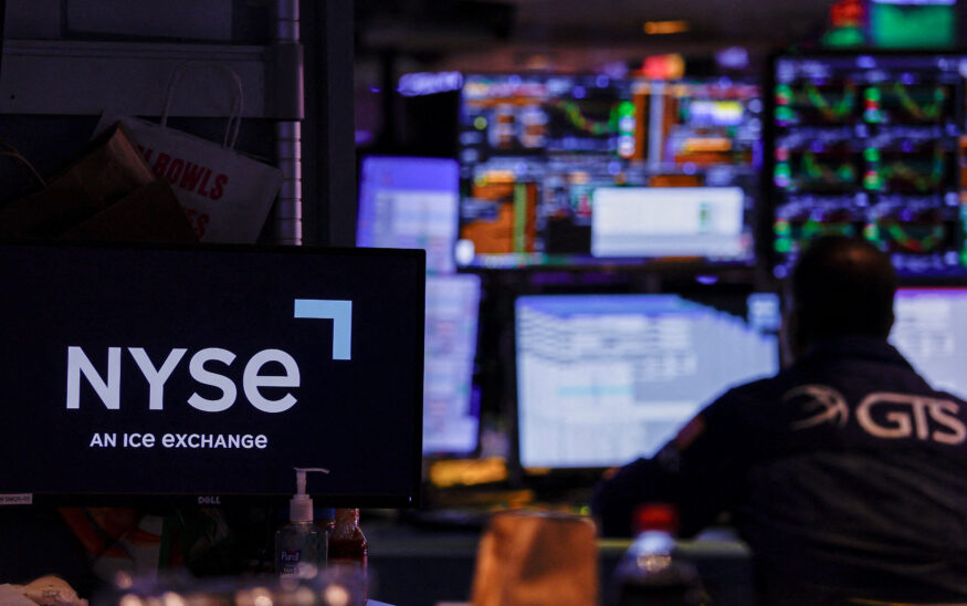 FILE PHOTO: A trader works on the floor of the New York Stock Exchange (NYSE), in New York City