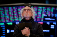 FILE PHOTO: Traders work on the floor of the NYSE in New York