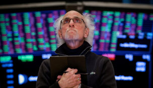 FILE PHOTO: Traders work on the floor of the NYSE in New York