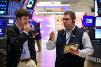 Traders work on the floor of the NYSE in New York