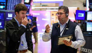 Traders work on the floor of the NYSE in New York