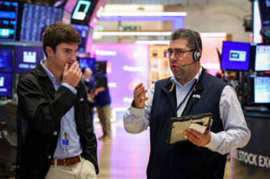 Traders work on the floor of the NYSE in New York