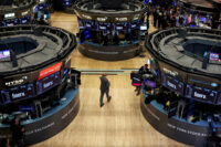 Traders work on the floor at the New York Stock Exchange (NYSE) in New York City, U.S., April 3, 2025. REUTERS/Brendan McDermid/File Photo