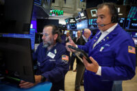 Traders work on the floor of the NYSE in New York