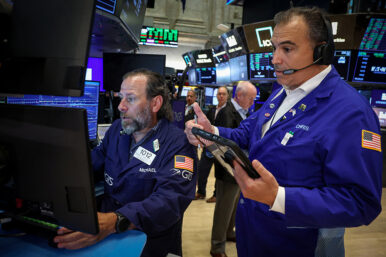 Traders work on the floor of the NYSE in New York