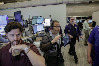FILE PHOTO: Futures-options traders work on the floor at the New York Stock Exchange’s NYSE American (AMEX) in New York City
