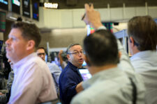 Traders work on the floor of the NYSE in New York