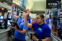 Traders work on the floor of the NYSE in New York
