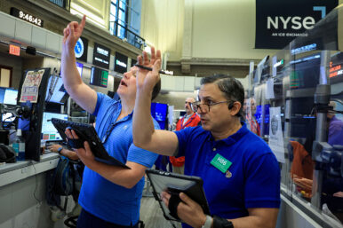 Traders work on the floor of the NYSE in New York