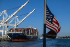 A cargo ship full of shipping containers is seen at the port of Oakland, California