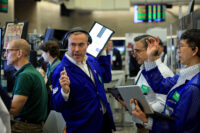 Traders work on the floor of the NYSE in New York