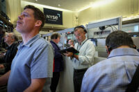 Traders work on the floor of the NYSE in New York
