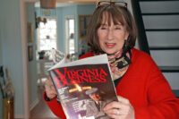 One of Virginia Business magazine’s original staff writers, Lisa Antonelli Bacon recalls swaddling the magazine’s first issue in a baby blanket to deliver it to Media General executives in March 1986. Bacon photo by Jay Paul
