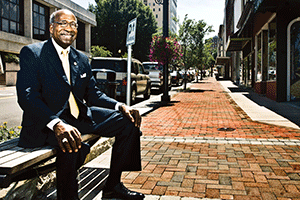 Mayor Sherman Saunders, a proponent of downtown revitalization, is surrounded by recently completed sidewalk and landscape additions on Main Street.