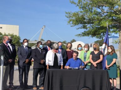 Gov. Ralph Northam signs offshore wind legislation at a June 29 ceremony in Virginia Beach (Photo by Beth Cooper)