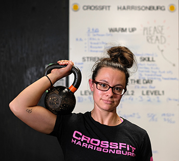 “There’s definitely a new normal” at CrossFit Harrisonburg, with participants tapping toes instead of giving each other high-fives, says coach Maria Hayden. Photo by Norm Shafer