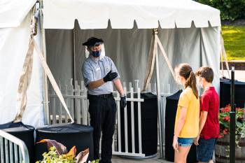Kings Dominion employee performs temperature checks upon patrons' arrival to park. Photo courtesy Kings Dominion.