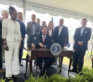 Gov. Glenn Youngkin signed a bill July 10, 2024, at the North Anna nuclear power plant in Louisa County, joined by Lt. Gov. Winsome Earle-Sears, Virginia lawmakers and representatives of Dominion Energy. Photo by Kate Andrews | Virginia Business
