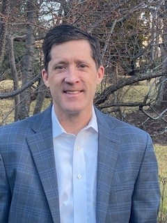 A man wearing a blue blazer. 